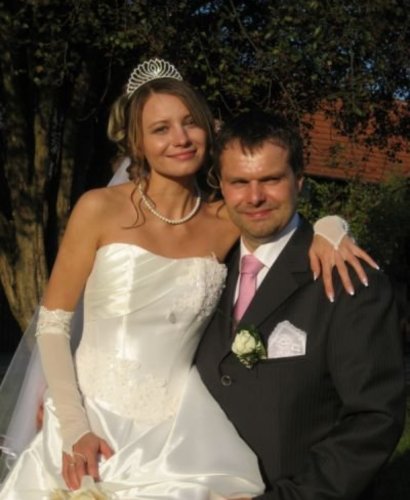 Bride in a white gown and tiara with her groom