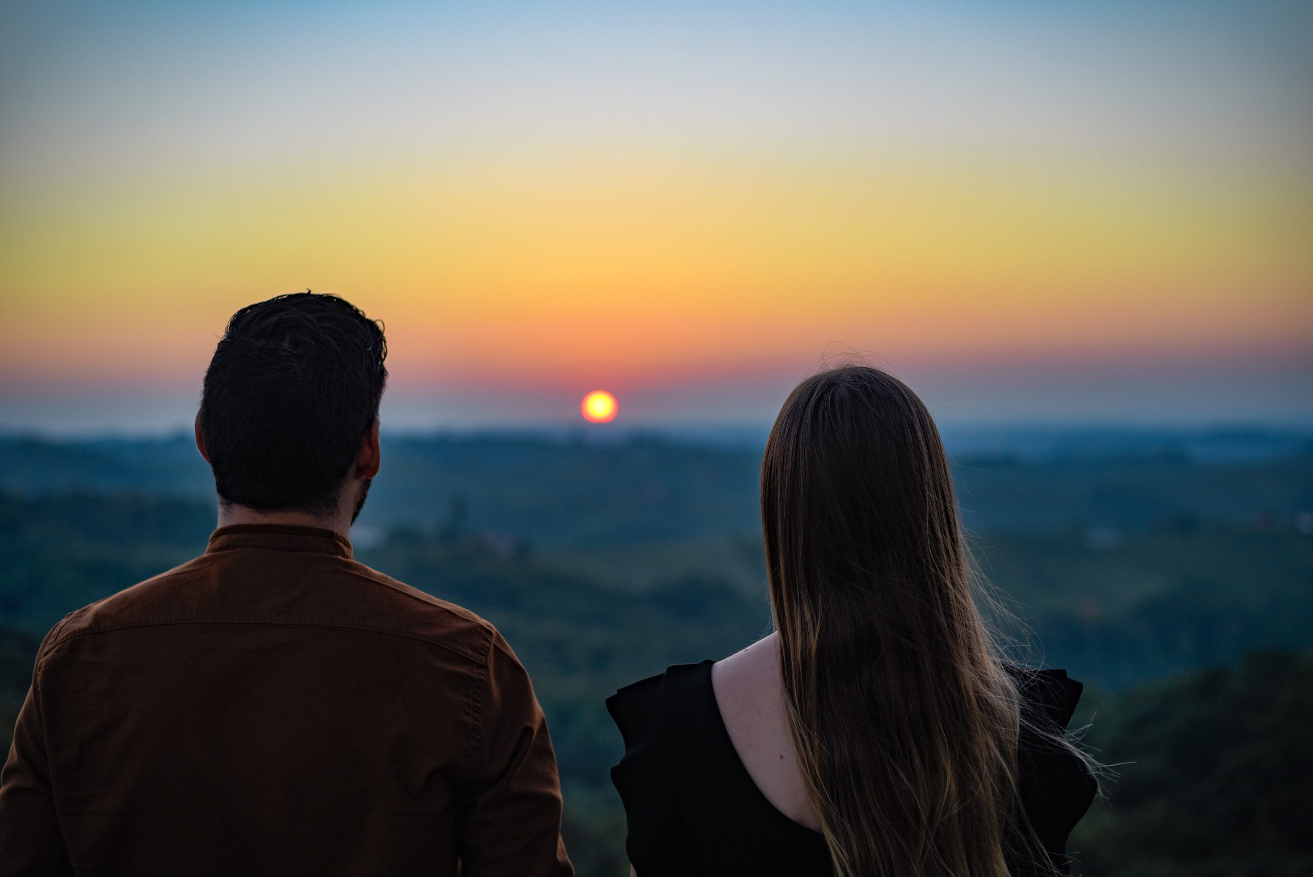 Khmelnytskyi Women date mood image showing a couple watching sunset together in a romantic and serious atmosphere