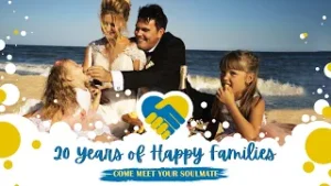 Beachside celebration image: happy couple with two young girls, promoting '20 years of happy families' and 'Come meet your soulmate' banner with a heart handshake logo on a sunny day.